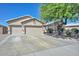 Well maintained traditional single-story home with a large driveway, desert landscaping, and a two car garage at 11580 N 86Th Ln, Peoria, AZ 85345