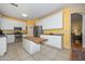 Kitchen features an island with butcher block top, stainless appliances, and leads into the dining room at 11580 N 86Th Ln, Peoria, AZ 85345