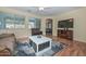 Spacious living room featuring hardwood floors, large windows, and a comfortable seating area at 11580 N 86Th Ln, Peoria, AZ 85345