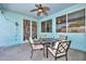 Covered patio with ceiling fan offers a cozy outdoor dining space, perfect for relaxing and entertaining at 11580 N 86Th Ln, Peoria, AZ 85345