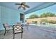 Covered patio featuring a ceiling fan, dining table, and a view of the sparkling pool and backyard oasis at 11580 N 86Th Ln, Peoria, AZ 85345