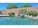 Backyard swimming pool features rock waterfall and beautiful desert landscaping at 11580 N 86Th Ln, Peoria, AZ 85345