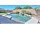 Sparkling pool with lush desert landscaping, boulder waterfall and block fence at 11580 N 86Th Ln, Peoria, AZ 85345