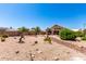 Expansive backyard features desert landscaping with drought tolerant plants and a covered patio at 11631 W Lemon Ct, Surprise, AZ 85378