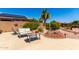 Desert landscaped backyard with stone features, solar panels, patio and seating area at 11631 W Lemon Ct, Surprise, AZ 85378