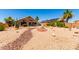 Expansive backyard with desert landscaping, patio, drought tolerant vegetation and solar panels at 11631 W Lemon Ct, Surprise, AZ 85378