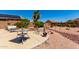 Backyard features solar panels, desert landscaping, seating and shaded patio at 11631 W Lemon Ct, Surprise, AZ 85378