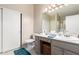 Bathroom featuring a single sink vanity, toilet, closet, and walk-in shower with glass door at 11631 W Lemon Ct, Surprise, AZ 85378