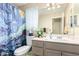 Neutral bathroom with Starry Night shower curtain, vanity, and decorative touches at 11631 W Lemon Ct, Surprise, AZ 85378