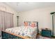 Well-lit bedroom featuring a patterned bedspread, side tables, and cozy decor at 11631 W Lemon Ct, Surprise, AZ 85378