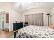 Inviting bedroom with bright floral bedding, hardwood floors, and a vaulted ceiling at 11631 W Lemon Ct, Surprise, AZ 85378