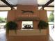 Inviting clubhouse fireplace adorned with the 'Coyote Lakes' logo, offering a cozy ambiance at 11631 W Lemon Ct, Surprise, AZ 85378