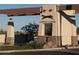 Elegant entrance to Coyote Lakes, with stone accents and lush landscaping at 11631 W Lemon Ct, Surprise, AZ 85378