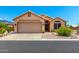 Charming single-story home with a desert landscape, tile roof, and a two-car garage at 11631 W Lemon Ct, Surprise, AZ 85378