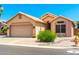 Charming single-story home with a desert landscape, tile roof, and a two-car garage at 11631 W Lemon Ct, Surprise, AZ 85378