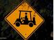 Bright yellow golf cart crossing sign posted near the golf course at 11631 W Lemon Ct, Surprise, AZ 85378