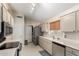 Spacious kitchen with stainless steel appliances, tile floors, and a window over the sink at 11631 W Lemon Ct, Surprise, AZ 85378