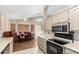 Bright kitchen and dining area with wood floors and modern stainless steel microwave and oven at 11631 W Lemon Ct, Surprise, AZ 85378