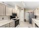Open-concept kitchen featuring tile floors, stainless steel appliances, and recessed lighting at 11631 W Lemon Ct, Surprise, AZ 85378