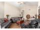 Cozy living room with vaulted ceilings, comfortable seating, and wood-look floors at 11631 W Lemon Ct, Surprise, AZ 85378