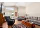 Bright living room featuring vaulted ceilings, wood-look floors, and neutral paint at 11631 W Lemon Ct, Surprise, AZ 85378