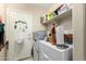 Functional mud room featuring storage, utility appliances, and convenient exterior access at 11631 W Lemon Ct, Surprise, AZ 85378