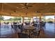 Outdoor covered patio featuring dining tables and chairs overlooking the beautiful golf course at 11631 W Lemon Ct, Surprise, AZ 85378