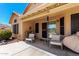 Covered patio with outdoor seating, sliding glass doors to the house and desert landscaping at 11631 W Lemon Ct, Surprise, AZ 85378