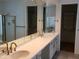 Bathroom with dual sinks, walk-in shower and quartz countertops at 1257 E Voltaire Ave, Phoenix, AZ 85022
