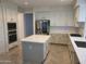 Modern kitchen featuring white cabinetry, stainless steel appliances, and a center island at 1257 E Voltaire Ave, Phoenix, AZ 85022
