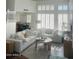 Bright living room with large windows, plush sofas, and a stylish coffee table at 1257 E Voltaire Ave, Phoenix, AZ 85022