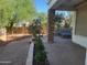 Cozy covered patio featuring stone columns, gravel, and patio furniture, perfect for outdoor entertaining at 1257 E Voltaire Ave, Phoenix, AZ 85022