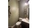 Stylish half bathroom featuring a unique patterned accent wall and modern sink at 1350 S Greenfield Rd # 1221, Mesa, AZ 85206
