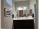 Bathroom with double sink vanity, framed mirror, and blue towel accents at 1350 S Greenfield Rd # 1221, Mesa, AZ 85206