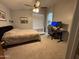 Bedroom with neutral carpet, ceiling fan, and desk area at 1350 S Greenfield Rd # 1221, Mesa, AZ 85206
