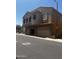 Exterior shot of a stucco building with stone accents and multiple garage doors in a well maintained neighborhood at 1350 S Greenfield Rd # 1221, Mesa, AZ 85206
