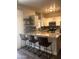Bright kitchen with white cabinets, stainless steel appliances, granite countertops, and stylish bar seating at 1350 S Greenfield Rd # 1221, Mesa, AZ 85206
