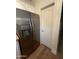 Stainless steel refrigerator next to a pantry in kitchen with wood floors at 1350 S Greenfield Rd # 1221, Mesa, AZ 85206