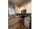 A well-lit kitchen with stainless steel appliances, granite countertops, and white cabinets at 1350 S Greenfield Rd # 1221, Mesa, AZ 85206