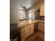 Open kitchen area with granite countertop island and stainless steel dishwasher at 1350 S Greenfield Rd # 1221, Mesa, AZ 85206