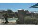 View of the community pool, surrounded by a metal fence, and featuring nearby shade structures at 1350 S Greenfield Rd # 1221, Mesa, AZ 85206