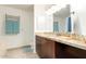 Spacious bathroom features granite countertops, wood cabinetry, and an oversized mirror at 14000 N 94Th St # 2187, Scottsdale, AZ 85260