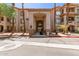 Inviting condo entrance with grand archway, desert landscaping, and tall palm trees creates curb appeal at 14000 N 94Th St # 2187, Scottsdale, AZ 85260