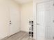 Bright hallway with light wood-look flooring and white doors, shoe shelf in background at 14000 N 94Th St # 2187, Scottsdale, AZ 85260