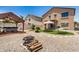 Spacious backyard with a gazebo, hot tub, artificial turf, and fire pit, great for outdoor relaxation and fun at 15006 N 172Nd Ln, Surprise, AZ 85388