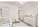 Bright Bedroom with a crib, changing table, and closet, offering a functional and peaceful space at 15006 N 172Nd Ln, Surprise, AZ 85388