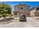 Two-story home featuring a two-car garage, neutral color scheme, and low maintenance desert landscaping at 15006 N 172Nd Ln, Surprise, AZ 85388
