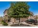 Charming two-story home with landscaped front and mature shade tree, offering a welcoming and well-kept appearance at 15006 N 172Nd Ln, Surprise, AZ 85388