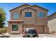 Charming two-story house with a well-maintained front yard and a convenient two-car garage, showcasing curb appeal at 15006 N 172Nd Ln, Surprise, AZ 85388