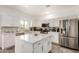 Kitchen with white cabinets, center island, stainless steel appliances, and modern finishes at 15006 N 172Nd Ln, Surprise, AZ 85388